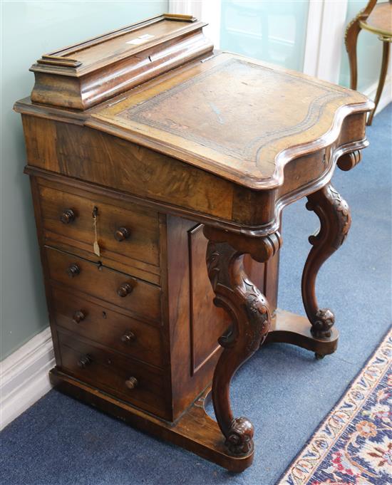A Victorian walnut serpentine fronted Davenport desk W.54cm